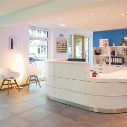 Heller und einladender Empfangsbereich der Hörgeräte Reichart Filiale in Oberhaching, ausgestattet für eine professionelle Hörgeräteberatung und -anpassung.